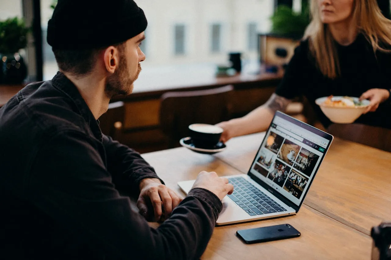 Freelancer working on a laptop in a cozy café setting. Ideal for remote work themes.